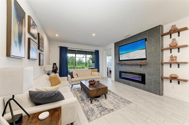 living room featuring a fireplace and light hardwood / wood-style flooring