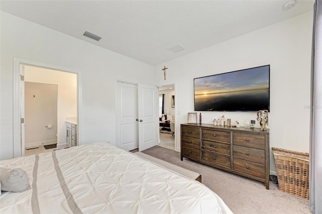 carpeted bedroom with connected bathroom