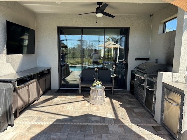 view of patio featuring ceiling fan, an outdoor kitchen, and area for grilling