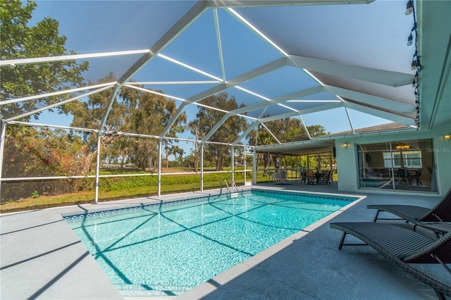 view of pool with a lanai and a patio area