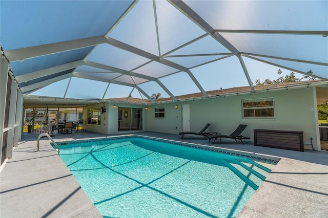 view of pool with a patio and a lanai