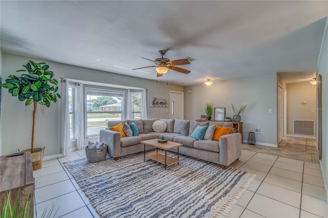 tiled living room with ceiling fan