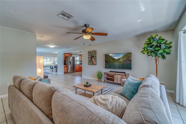 living room featuring light tile patterned floors and ceiling fan