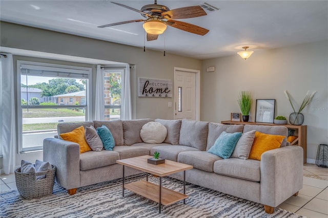 living room featuring light tile patterned flooring and ceiling fan