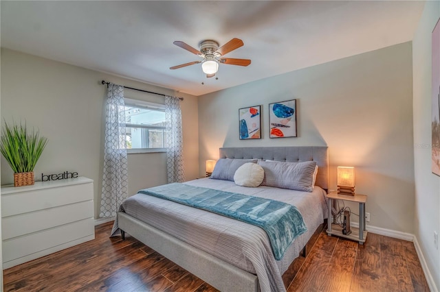 bedroom with dark hardwood / wood-style floors and ceiling fan