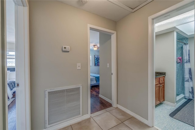 hall featuring light tile patterned floors