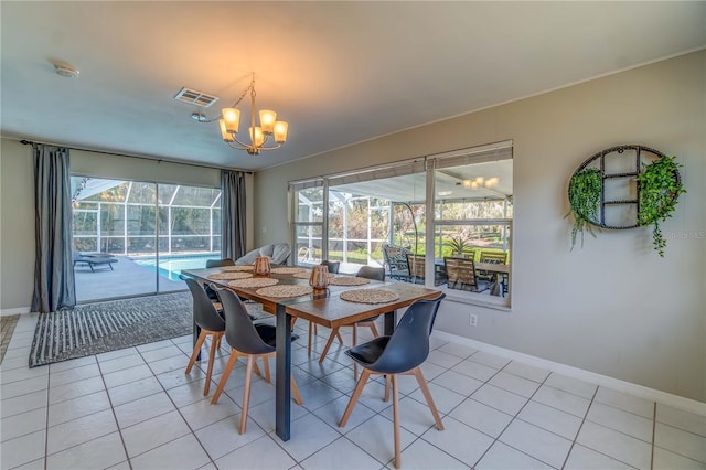 tiled dining area with a notable chandelier