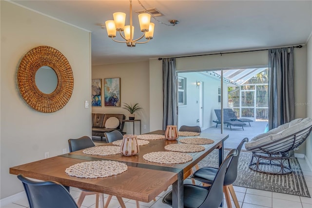 dining room featuring a notable chandelier and light tile patterned floors