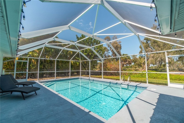 view of pool featuring a lanai and a patio