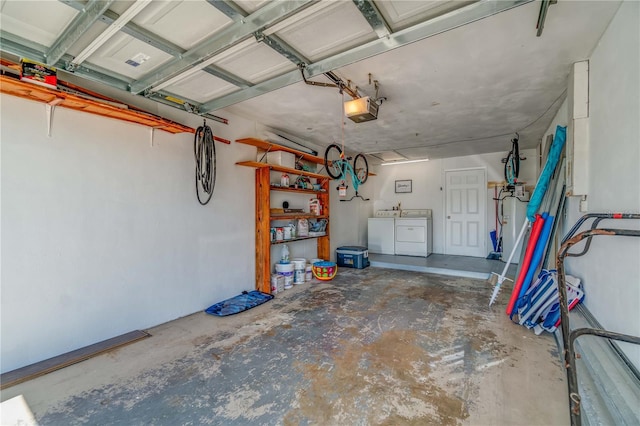 garage with a garage door opener and washer and dryer