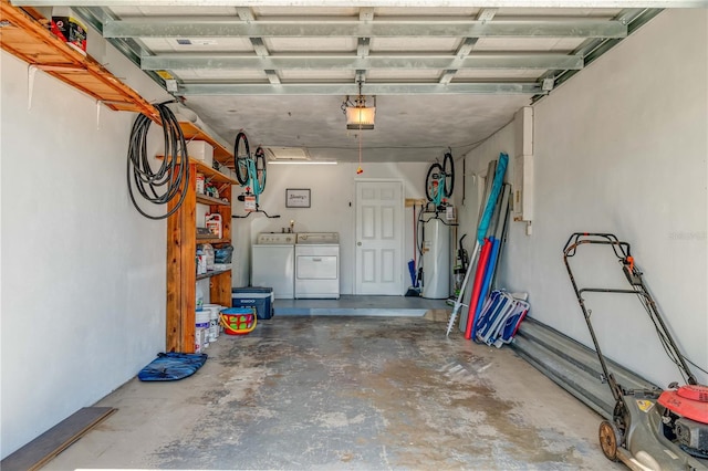 garage with a garage door opener, washer and dryer, and gas water heater