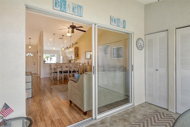 bathroom with ceiling fan, lofted ceiling, and wood-type flooring