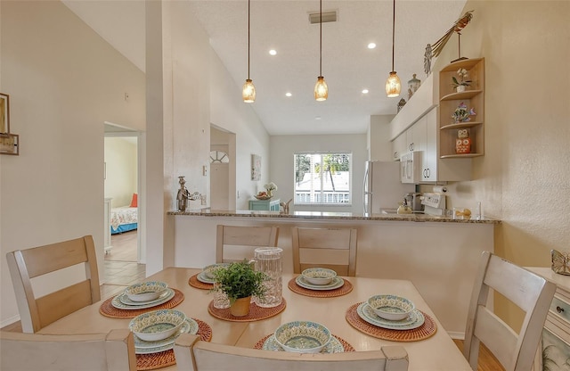 dining room featuring lofted ceiling