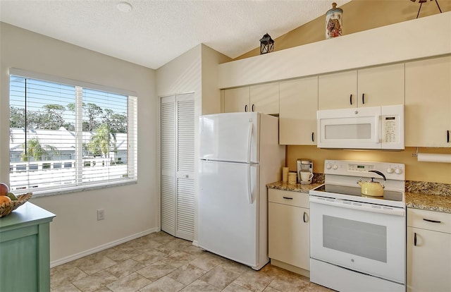 kitchen with light stone counters, white appliances, vaulted ceiling, and a textured ceiling