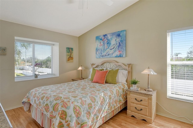 bedroom featuring ceiling fan, vaulted ceiling, and light wood-type flooring