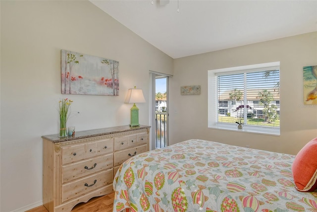 bedroom with multiple windows and lofted ceiling