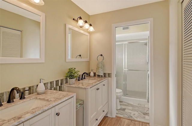 bathroom featuring vanity, toilet, and walk in shower