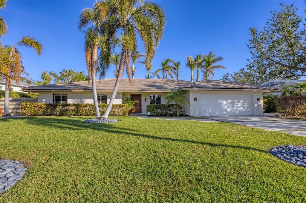 ranch-style home featuring a garage and a front yard