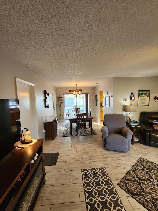 living room with a notable chandelier and a textured ceiling