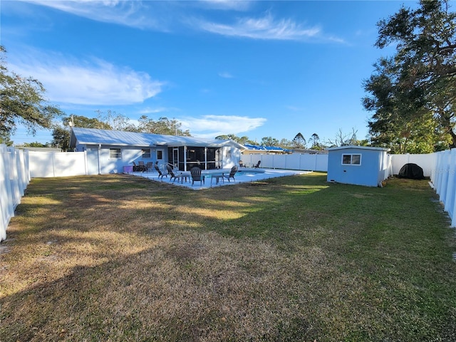 view of yard featuring an outdoor structure and a patio