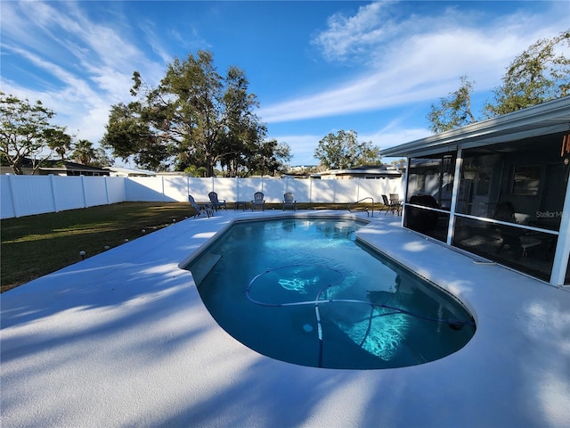 view of swimming pool featuring a sunroom