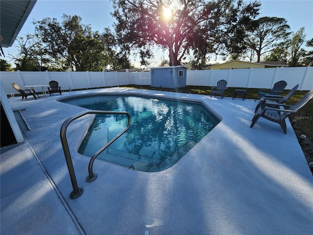 view of pool featuring a shed and a patio