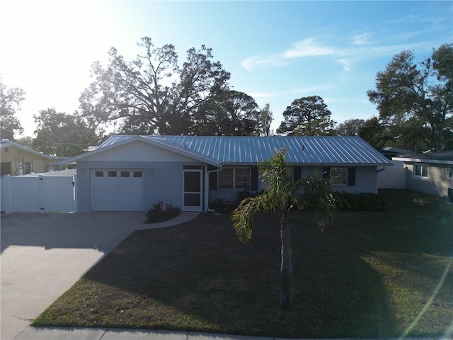 single story home featuring a garage and a front lawn