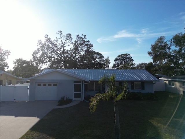 ranch-style house with a garage and a front lawn