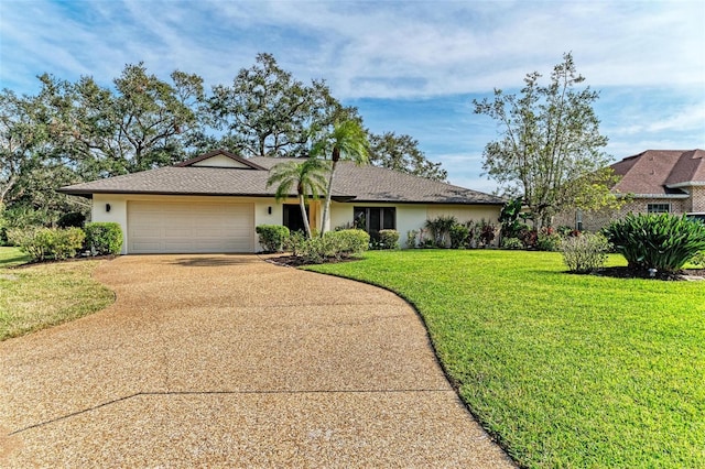 ranch-style home featuring a garage and a front yard