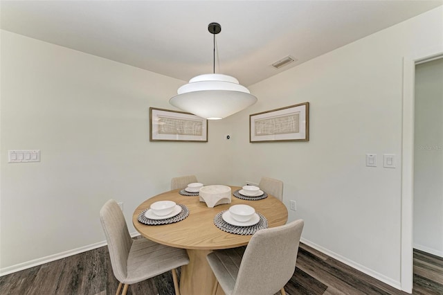 dining area with dark wood-type flooring