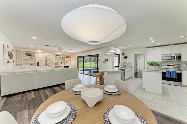 dining space with light hardwood / wood-style flooring