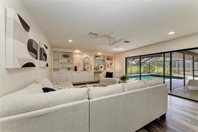 living room with hardwood / wood-style floors and ceiling fan