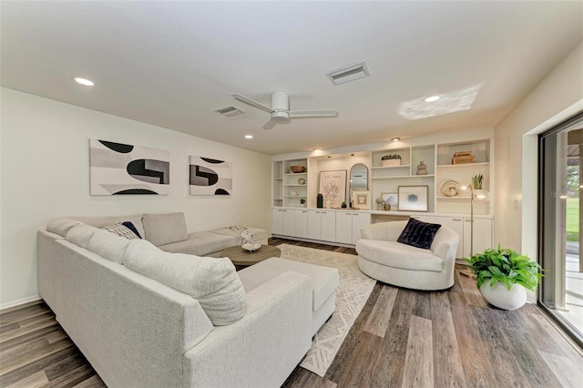 living room with wood-type flooring and ceiling fan