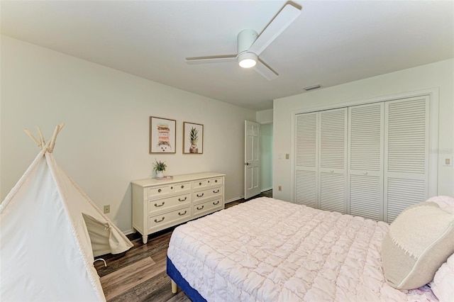 bedroom with ceiling fan, dark hardwood / wood-style flooring, and a closet