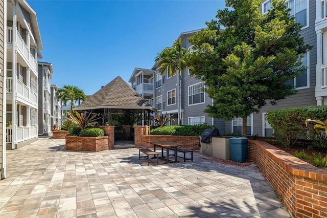 view of property's community with a gazebo and a patio