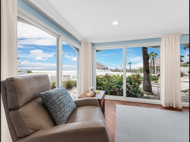 sunroom featuring a water view