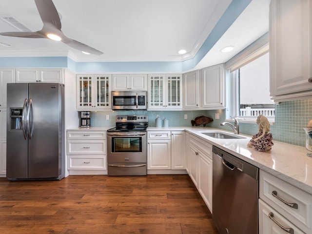 kitchen featuring sink, ceiling fan, appliances with stainless steel finishes, white cabinets, and dark hardwood / wood-style flooring