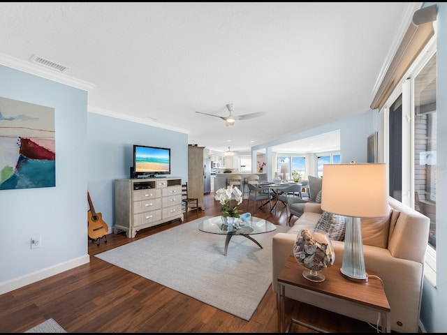 living room with hardwood / wood-style flooring, ceiling fan, and ornamental molding