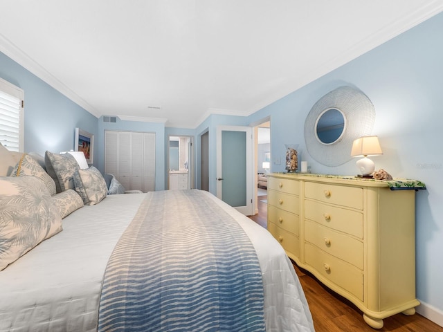 bedroom with ornamental molding, dark hardwood / wood-style floors, and a closet