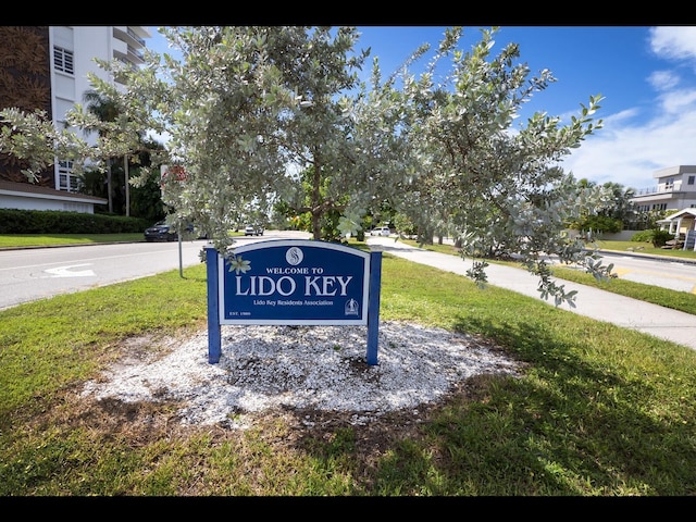 community / neighborhood sign with a yard