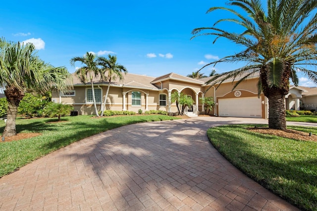 mediterranean / spanish home with a garage and a front yard