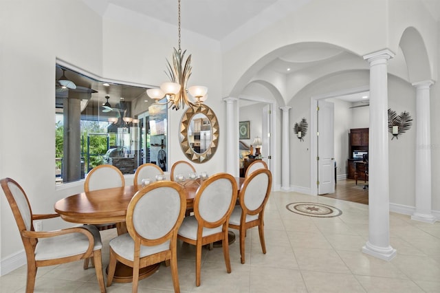 dining room with ornate columns, light tile patterned floors, and an inviting chandelier