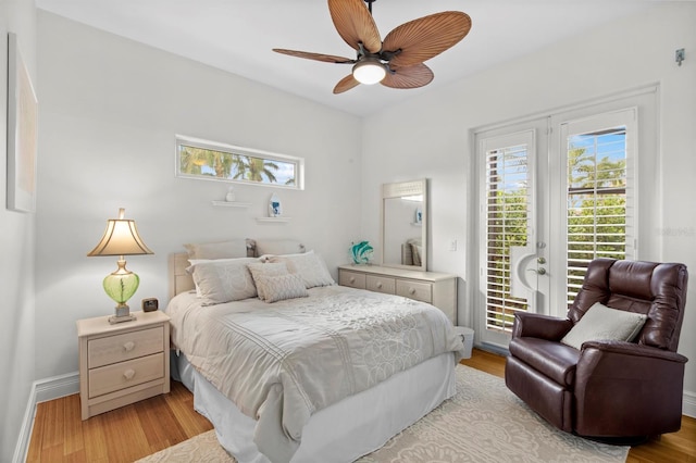 bedroom with multiple windows, ceiling fan, access to outside, and light wood-type flooring