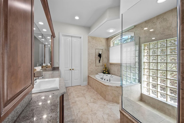 bathroom with independent shower and bath and vanity