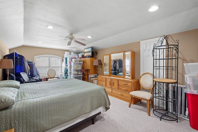 carpeted bedroom featuring ceiling fan and vaulted ceiling