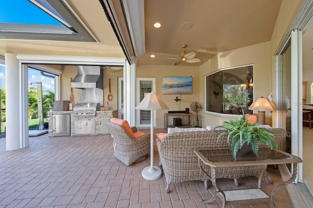 view of patio featuring ceiling fan, area for grilling, and an outdoor living space