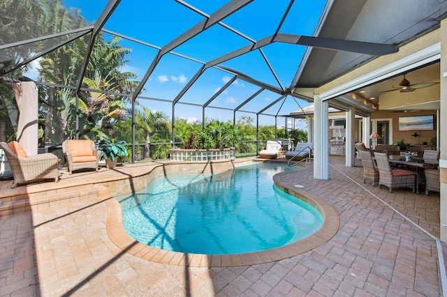 view of pool with a patio, a lanai, and ceiling fan