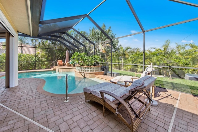 view of pool with a patio, glass enclosure, and a jacuzzi