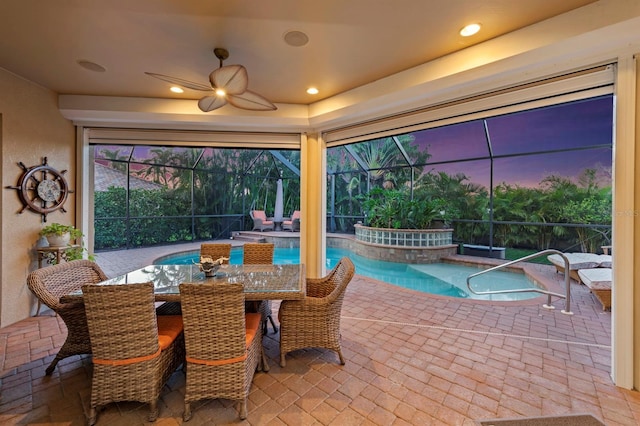 exterior space with a swimming pool with hot tub, a lanai, and ceiling fan