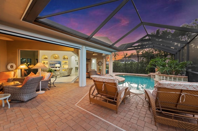 pool at dusk featuring an outdoor living space, a lanai, and a patio area